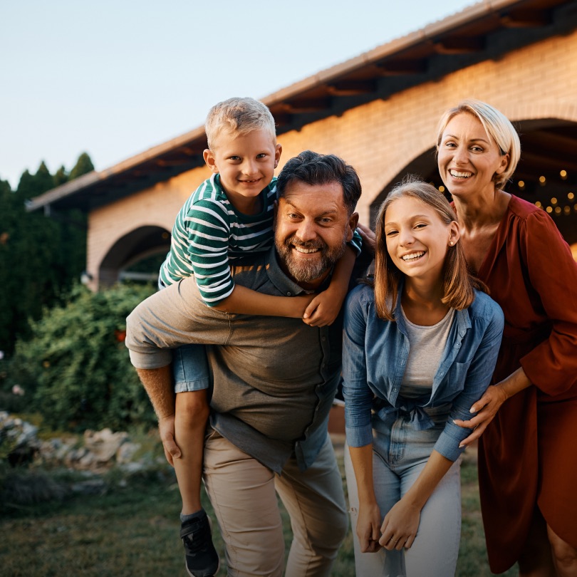 A happy family outside their home